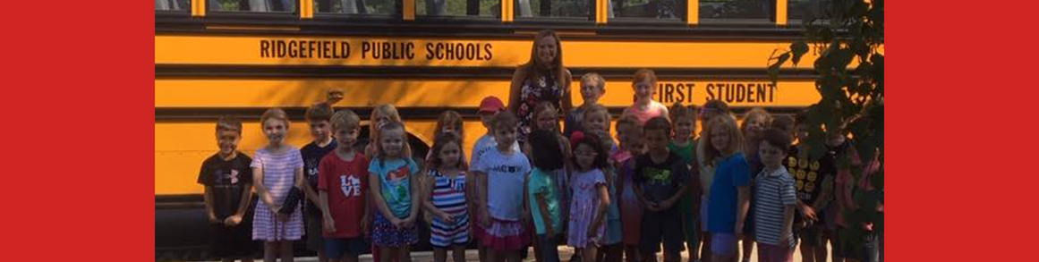 Scotland principal and students in front of school bus at kindergarten orientation